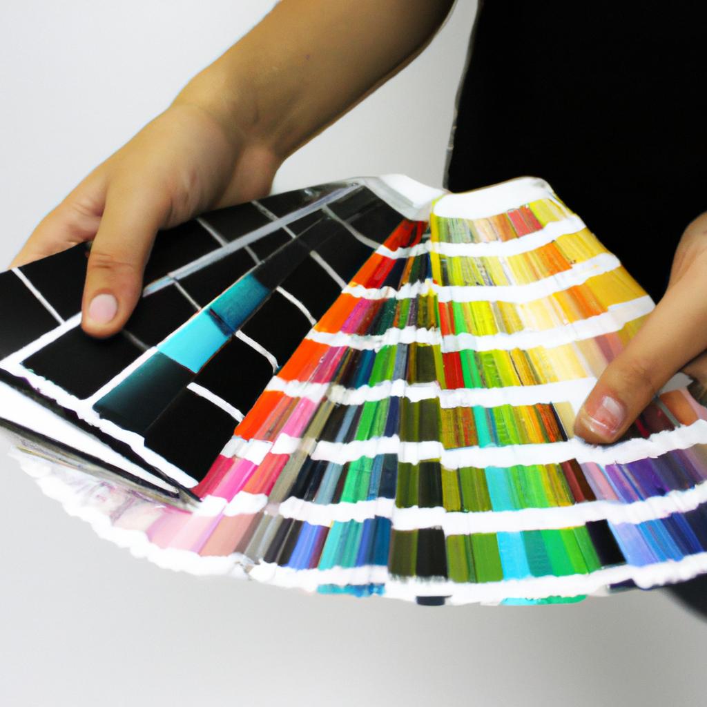 Person holding color palette, designing